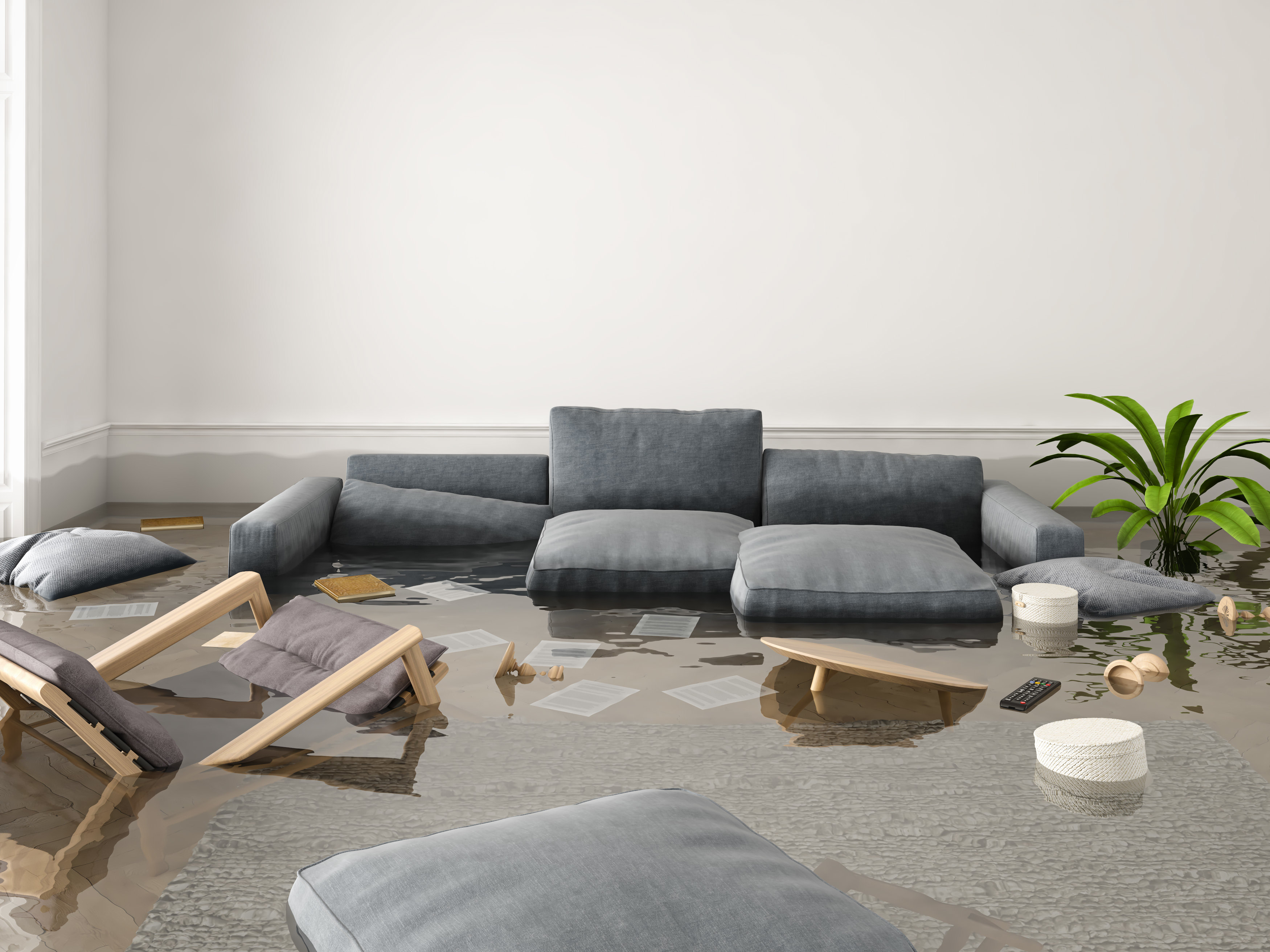 Ein überflutetes Wohnzimmer mit einer schwimmenden Couch und anderen Möbeln. 
