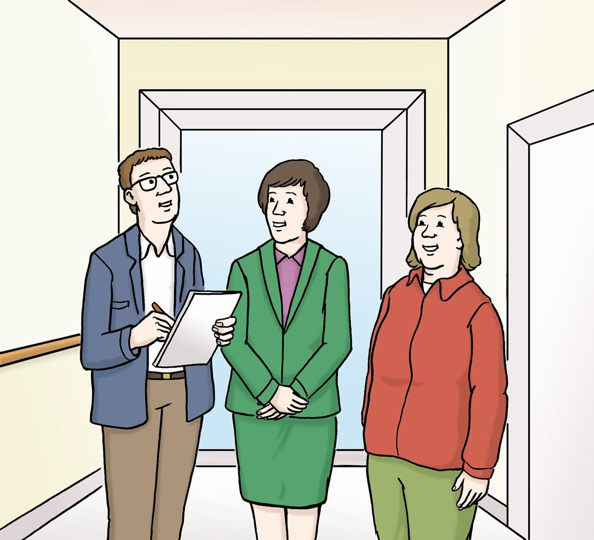 Mann berät zwei Frauen im flur