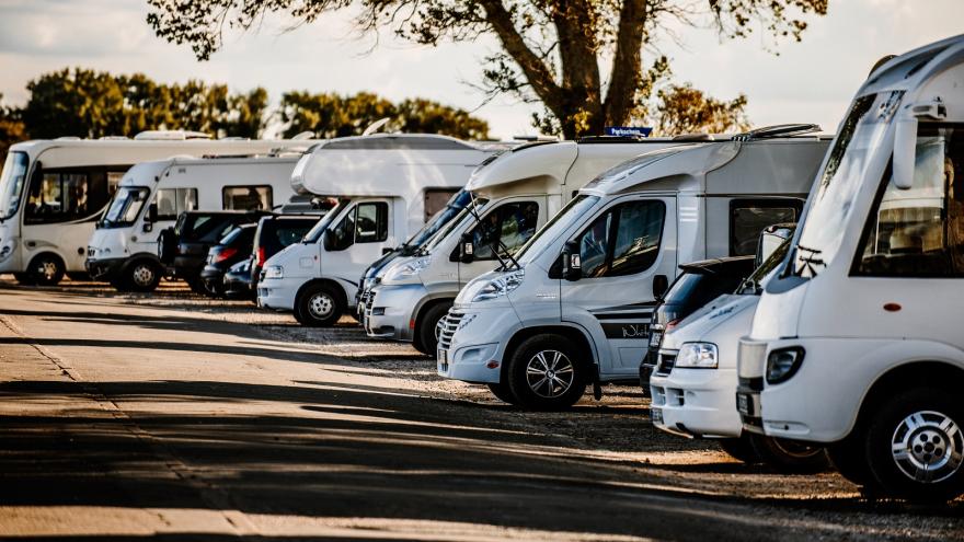 Mehrere Wohnmobile parken am Rand einer Straße