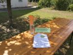 Ein Tisch mit einer Wasserflasche und einem Zettel.