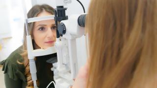 eine Frau macht bei einem Augenarzt einen Sehtest